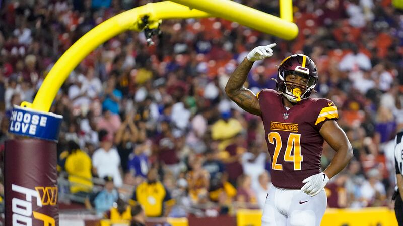 Washington Commanders running back Antonio Gibson celebrates after his touchdown during the...