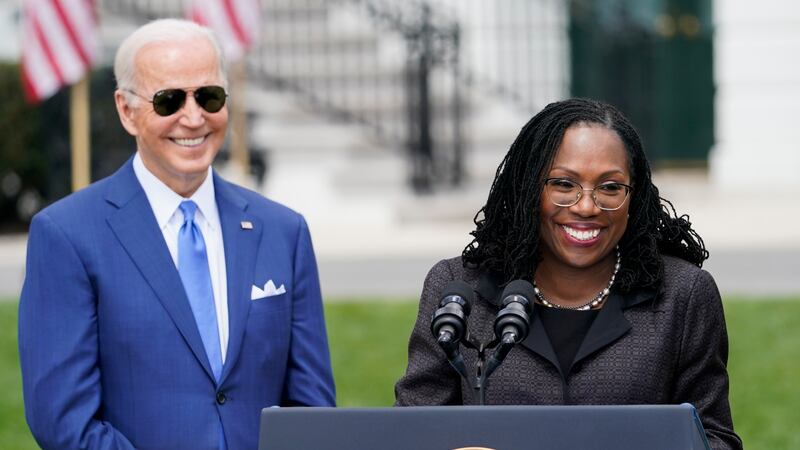 FILE - President Joe Biden listens as Judge Ketanji Brown Jackson speaks during an event on...