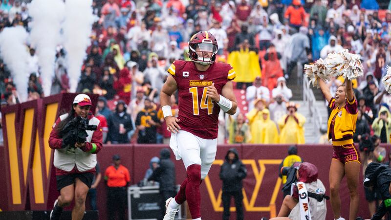 Washington Commanders quarterback Sam Howell (14) is introduced before an NFL football game...