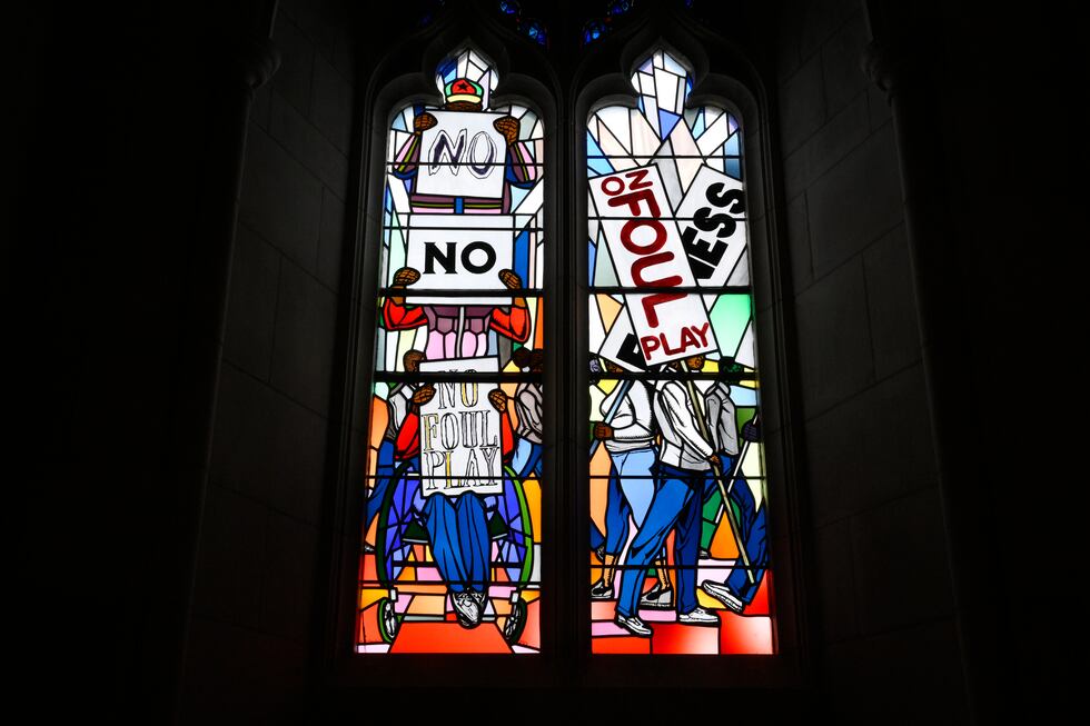 Light shines through new stained-glass windows with a theme of racial justice during an...